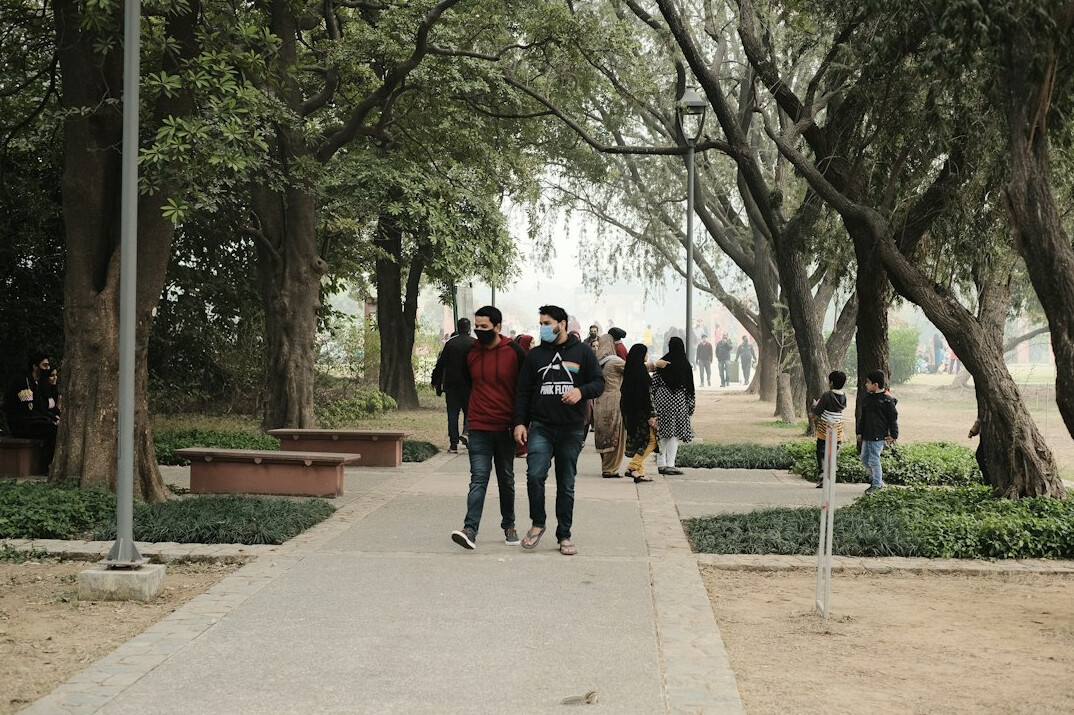 Colleagues having a walking meeting outdoors in a park